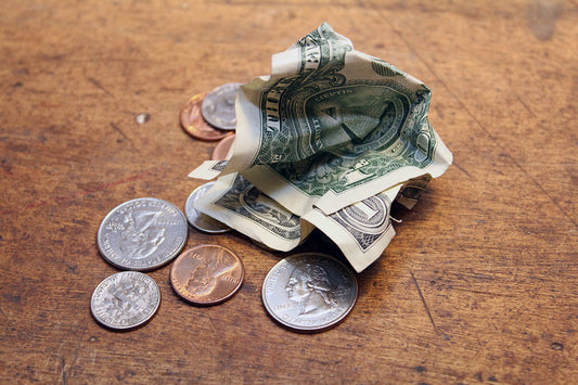 Free Loose Change and Crumpled Dollar Bills Stock Photography