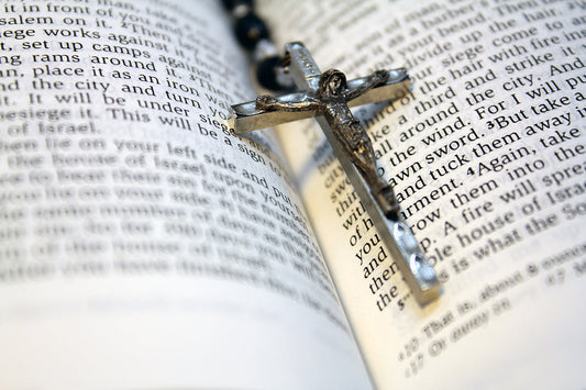 Free Crucifix Resting in Open Bible Stock Photography