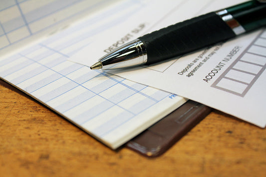 Free Pen and Deposit Slip on Ledger Stock Photography