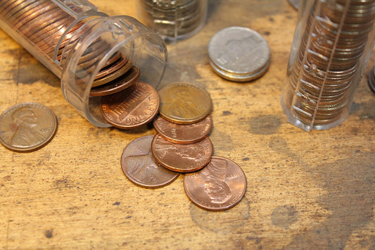 Free Loose Pennies and Coin Tubes Stock Photography