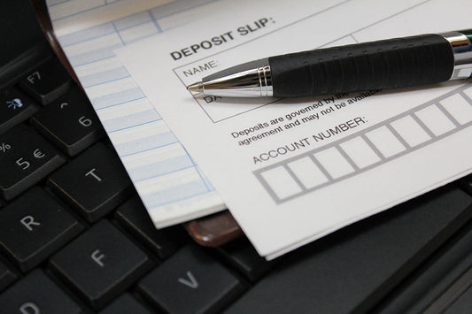 Free Deposit Slip and Pen on Keyboard Stock Photography